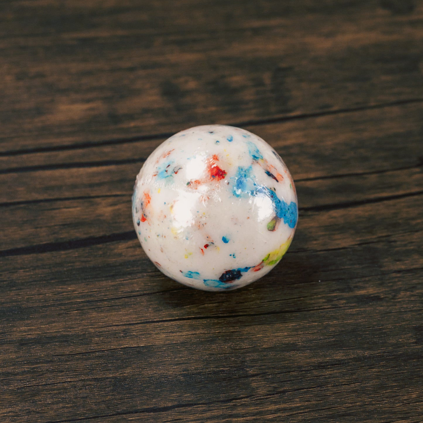a giant 2 1/4'' hard candy coated jawbreaker with multiple layers with a candy center will keep you busy for a while!