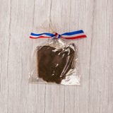 the shape of Ohio in smooth milk chocolate placed in a clear cello bag and tied with a red, white and blue ribbon.