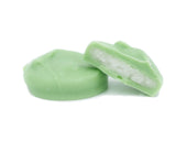 white peppermint cream center covered in green coating in a pound box.