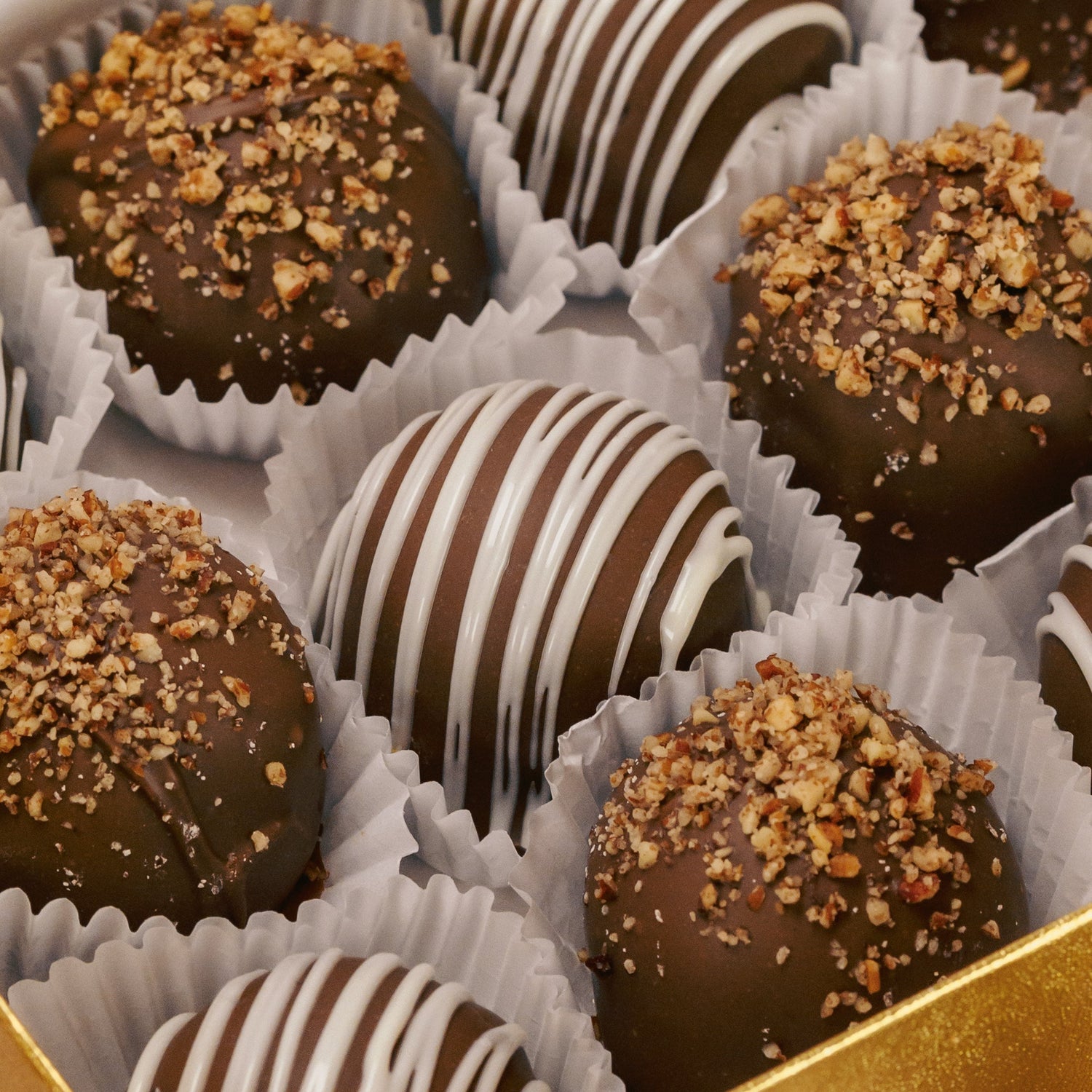 Marie's Truffles come in chocolate with drizzle or chocolate with crushed pecans. In a box of 6 or 12.