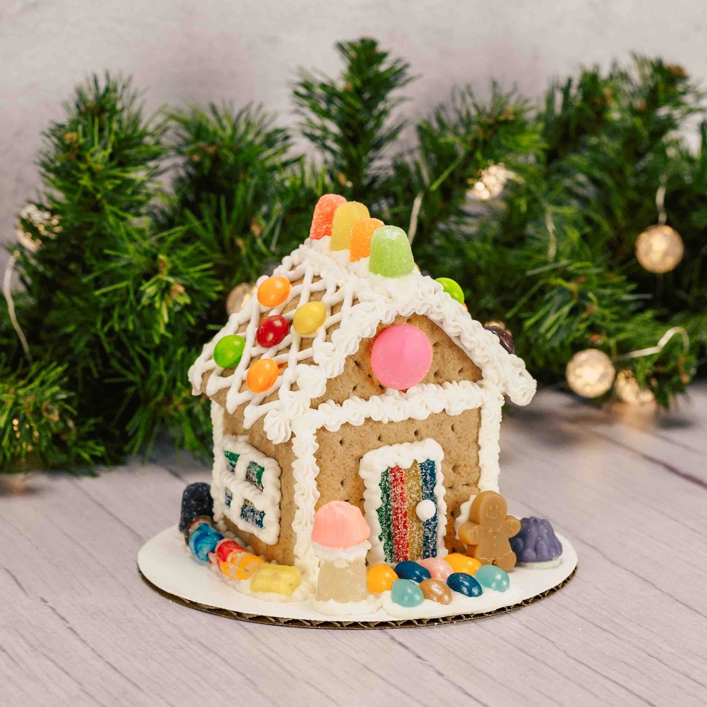 A ready-to-decorate gingerbread house kit featuring a fully assembled gingerbread house; made out of Graham Crackers, assorted colorful candies, and tube of icing (colors vary) —everything you need to add your own festive decorations with no building required. For in-store pickup in West Liberty, Ohio ONLY!