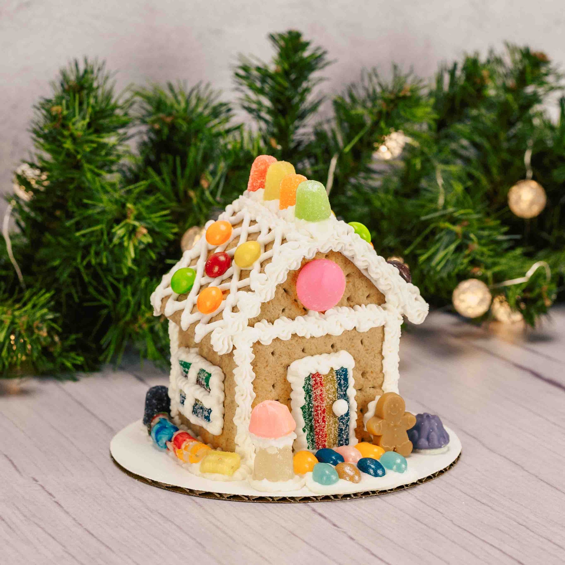 A ready-to-decorate gingerbread house kit featuring a fully assembled gingerbread house; made out of Graham Crackers, assorted colorful candies, and tube of icing (colors vary) —everything you need to add your own festive decorations with no building required. For in-store pickup in West Liberty, Ohio ONLY!