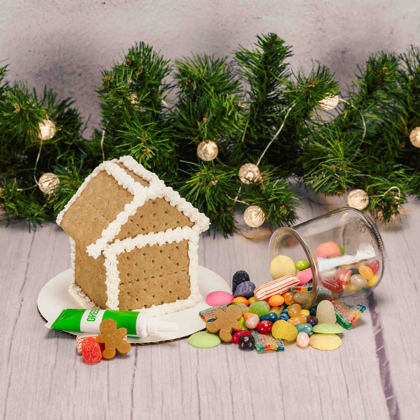 A ready-to-decorate gingerbread house kit featuring a fully assembled gingerbread house; made out of Graham Crackers, assorted colorful candies, and tube of icing (colors vary) —everything you need to add your own festive decorations with no building required. For in-store pickup in West Liberty, Ohio ONLY!