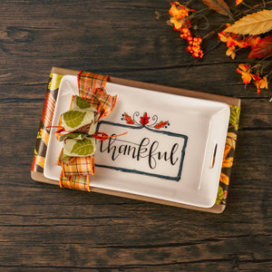 a ceramic tray reading 'Thankful' sits atop a one  pound box of assorted chocolates.