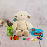 A lamb plush animal with some Easter candy packaged with it