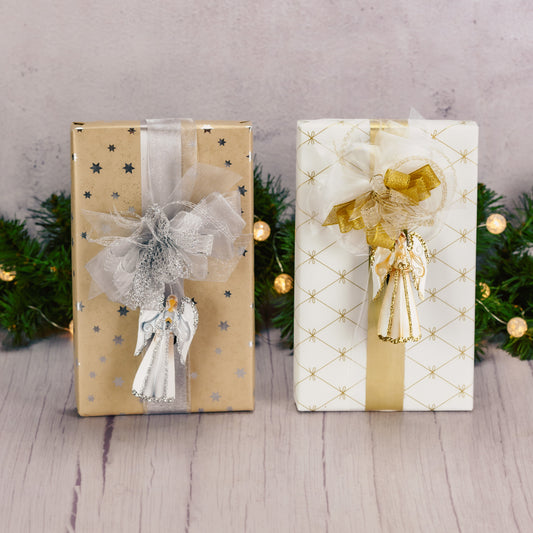 a one pound box of assorted chocolates is wrapped in gold or silver and topped with a matching springy metal angel ornament