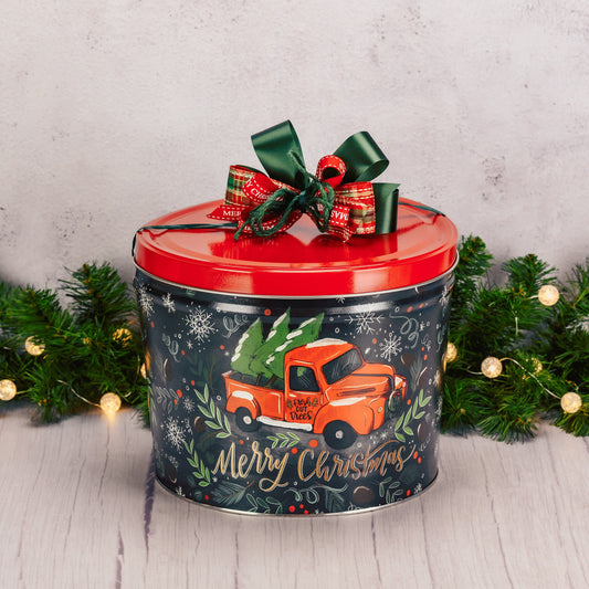 a large tin that reads 'Merry Christmas' is filled with over five pounds of sweet treats to celebrate the holiday with a large crowd!