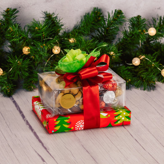 a small gift stack wrapped and tied in traditional red and greens is a lovely gift of appreciation this holiday. Includes an assorted box of chocolates, roasted & salted mixed nuts and milk chocolate foil bells. 