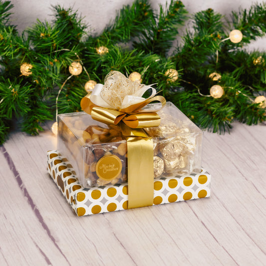 a lovely gift stack wrapped in gold is packaged with an assorted box of chocolates, roasted & salted mixed nuts and milk chocolate foil wrapped nuggets.