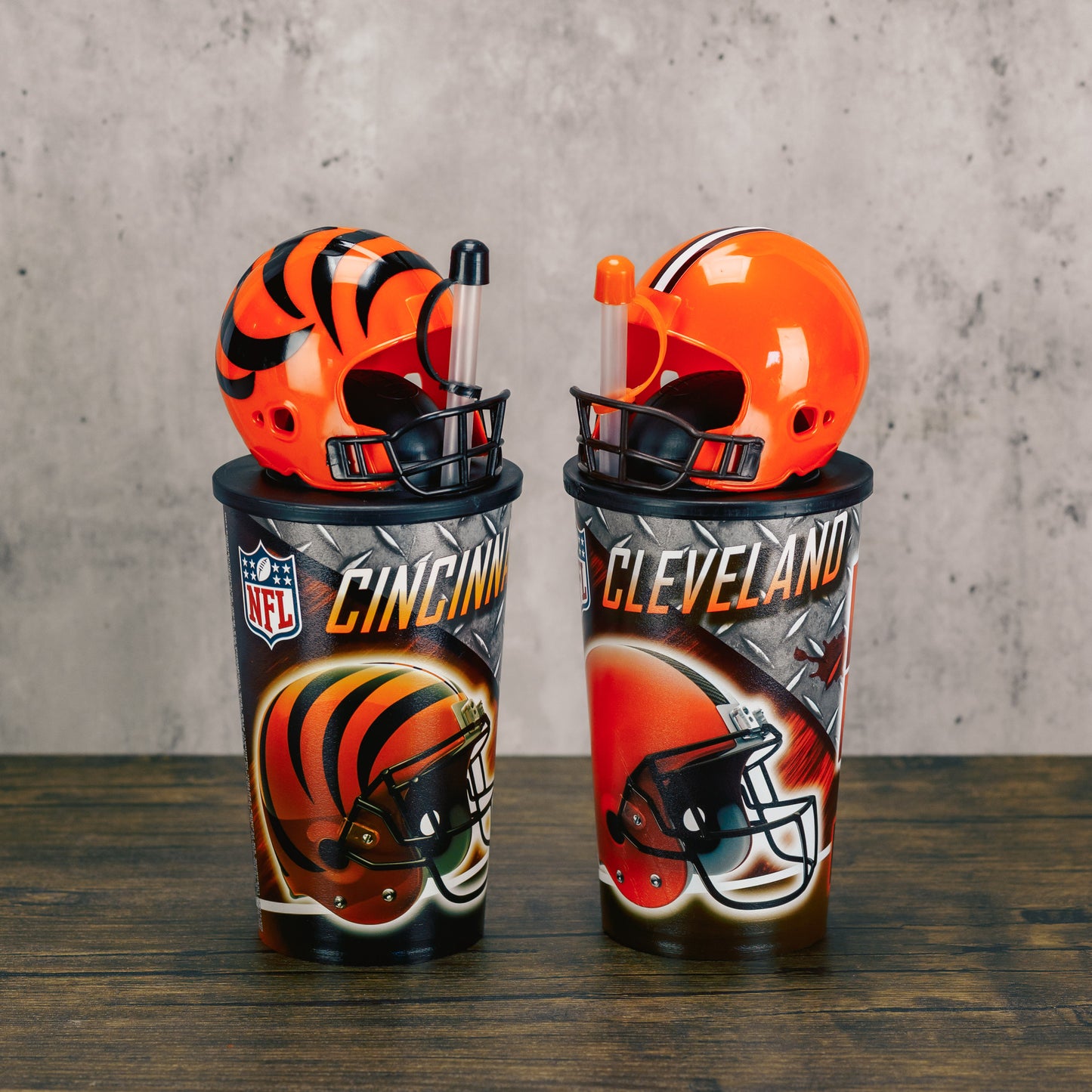 A Cleveland Browns or Cincinnati Bengals NFL official cup with straw and detectable football helmet cup is filled with sweet treats. 