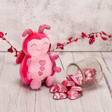 a pink lovebug plush to cuddle with and enjoy 3 oz. of Red Foil Milk Chocolate Hearts that come with it.
