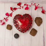 a red Mosser Glass heart shaped box is filled with 4 of our wonderful pieces of candy. 