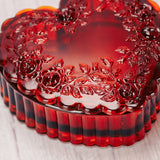 a red Mosser Glass heart shaped box is filled with 4 of our wonderful pieces of candy. 