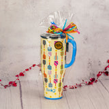 A swig pickleball print mega mug with straw is filled with sweet treats.