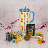 A swig pickleball print mega mug with straw is filled with sweet treats.