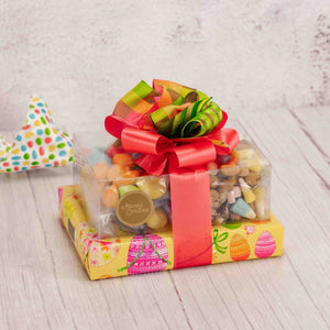  A small gift tower packaged with wonderful treats for all to enjoy (or not!). Presented in bright yellow egg paper with a lovely handmade bow on top to make a lasting impression. 1/2 lb. Eggstravagant Gummies 1/2 lb. Bunny Tracks Mix 1/2 lb. Milk and Dark Assortment