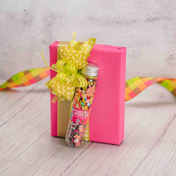  On those wet, damp and rainy spring days, conquer this 150-piece micro puzzle while enjoying the half pound box of indulgent Assorted Chocolates. Wrapped in bright pink and topped with a lovely handmade bow.   