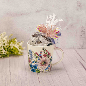     Over a half pound of our delicious Assorted Milk Chocolates is packaged inside this beautiful flower mug. Tied with a lovely handmade bow for an added touch. Mug is dishwasher and microwave safe. May every sip you take be sweet!