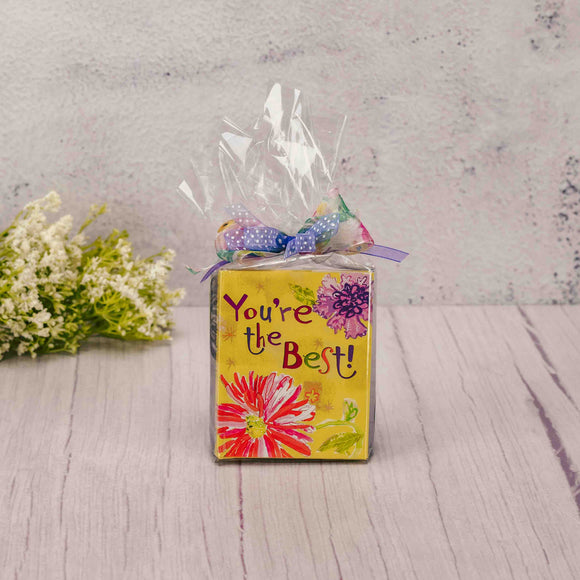 This gift may be small, but it sure is mighty! A petite book, 'You're the Best!', includes collections of quotes and quips that will encourages you to be the best! Attached to the ribbon bookmark is a 24K gold-plated flower charm, that could be worn on a bracelet or necklace. A sampler box of stupendous Assorted Chocolates is packaged with it. A perfect combination - a book and chocolates! 