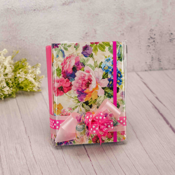 a half pound box of assorted chocolates is topped with a peony journal