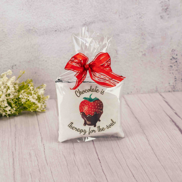 a small zipper pouch that reads 'chocolate is therapy for the soul' is filled with some candy