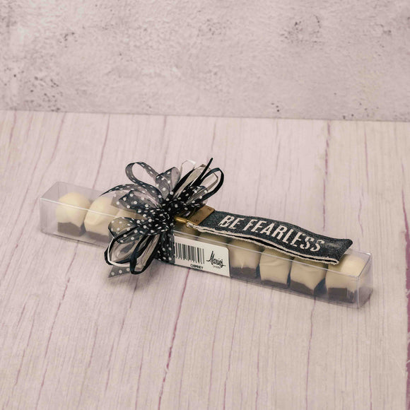 A package of Chimney Sweets paired with a canvas keychain that reads 'be fearless'