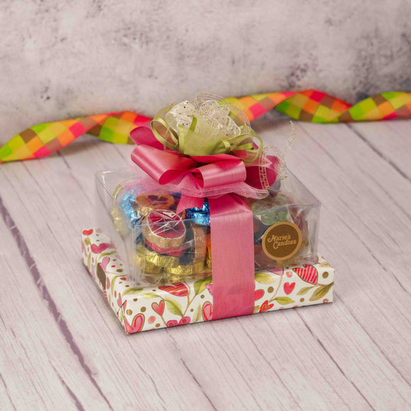 Trendy floral heart wrap and a wonderful handmade bow completes this gift stack, making it a tasteful gift for any spring occasion! Scrumptious treats included are: 1/2 lb. Milk Chocolate Foil Pansies 1/2 lb. Awesome Blossoms 1/2 lb. Assorted Milk & Dark Chocolates