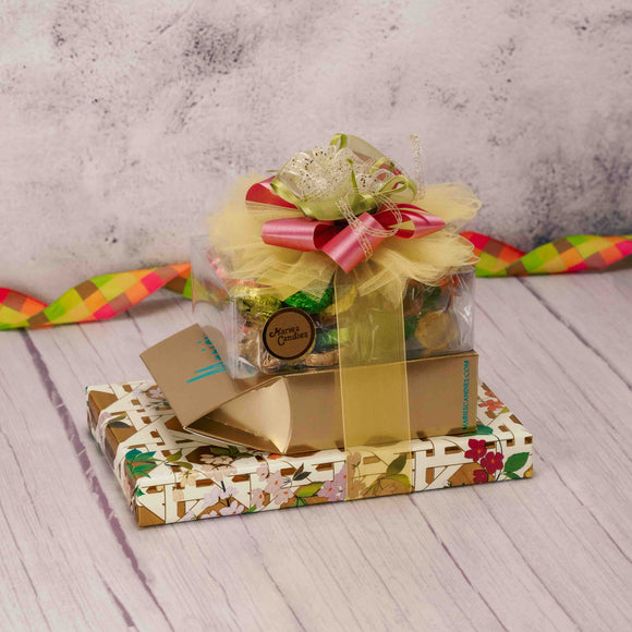   Make a lasting impression with this ultimate gift stack beautifully wrapped in spring floral lattice paper, with a splendid handmade bow. Made up with some of our fan favorites like:  1/2 lb. Awesome Blossoms 1/2 lb. Foil Pansies 1/2 lb. Milk Chocolate Potato Chips 1 lb. Milk & Dark Assorted Chocolates