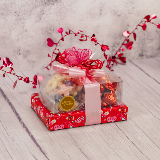 a Valentine gift stack to impress all with an assorted box, gummies and foil hearts.