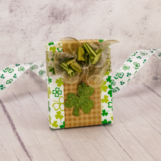 a half pound box of assorted chocolates wrapped and topped with a glittery shamrock ornament. Choose a mik or milk and dark assortment.