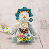 A dino plush animal with some Easter candy packaged with it