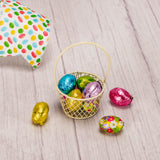 a small wire basket is filled with 3 ounces of milk chocolate foil eggs