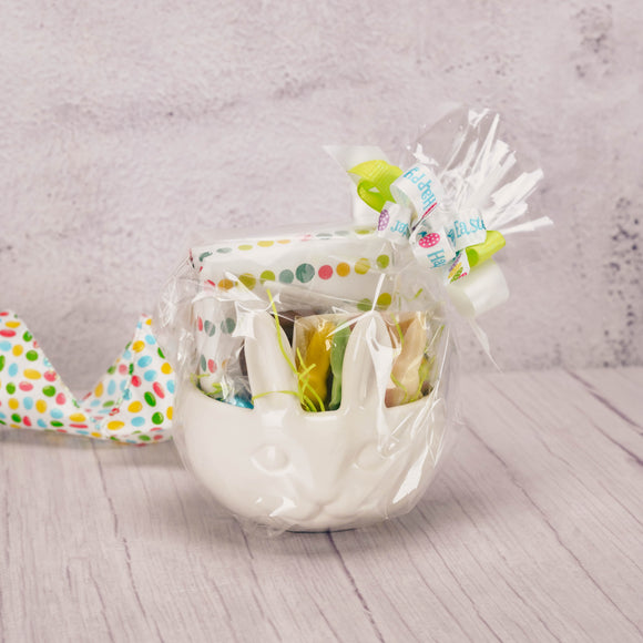 a white bunny face snack bowl is filled with Easter treats