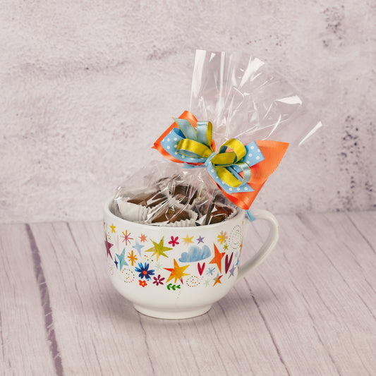 a large latte-styled mug that reads 'cup of success' on the inside is filled with a half pound of our assorted milk chocolates.