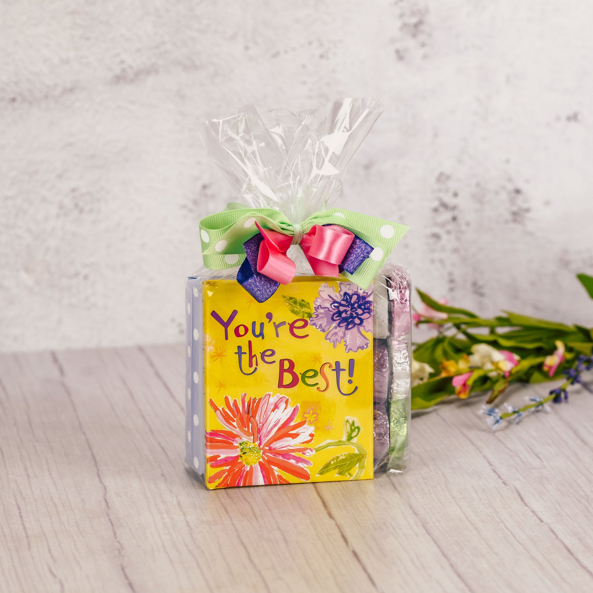 a small book 'You're the best' is packaged with a sampler box of assorted chocolates and 6 foil violets.