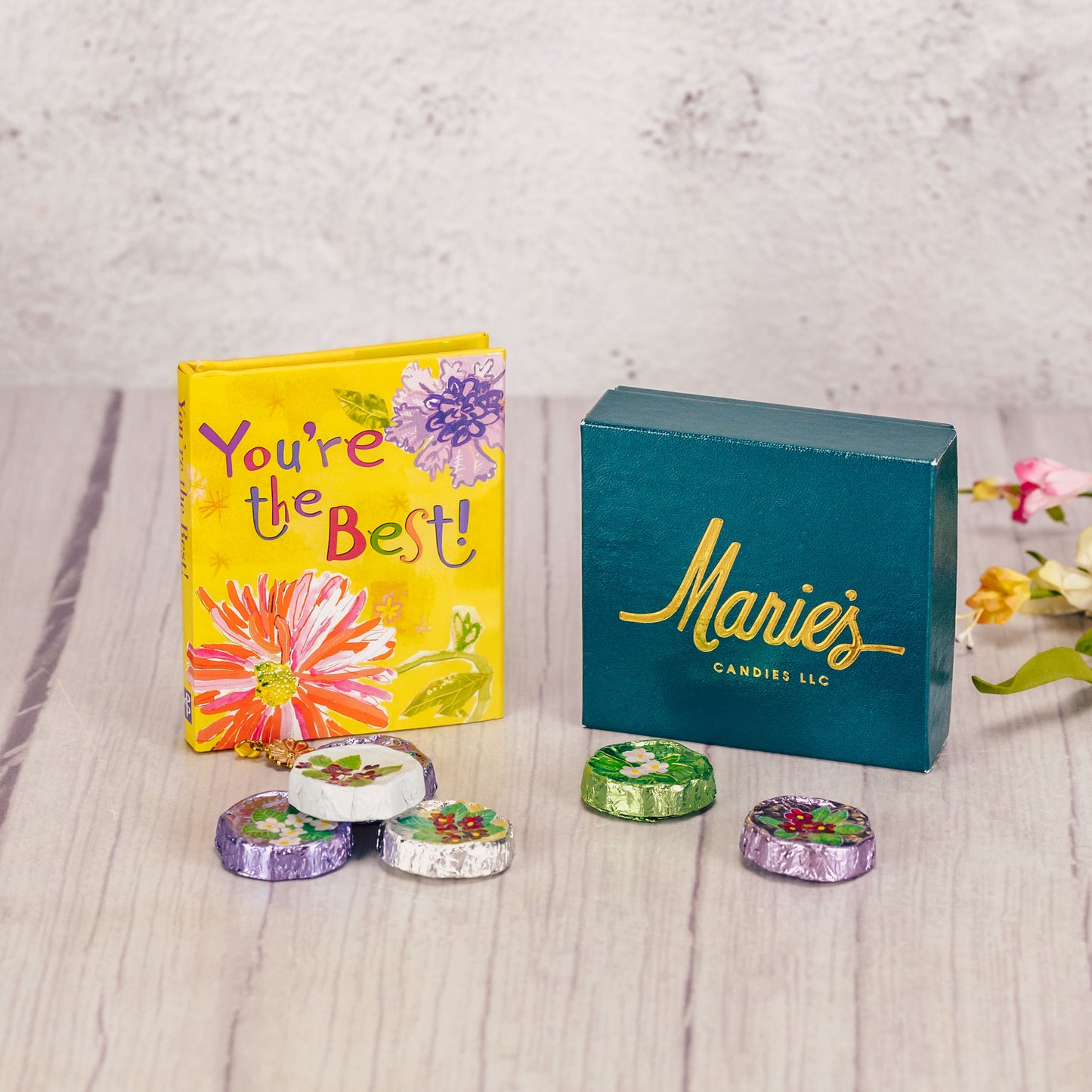 a small book 'You're the best' is packaged with a sampler box of assorted chocolates and 6 foil violets.