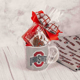 Impress the Buckeye fan in your life with this oversized Block O logo mug that features scarlet on one side and gray on the other. Packaged in a clear bag and tied with a festive handmade bow, we filled it with some of our indulgent candy like:  Scarlet & Gray Oreo  Cherry Jelly Belly Sports Beans  2 oz. Foil Footballs  Sampler 