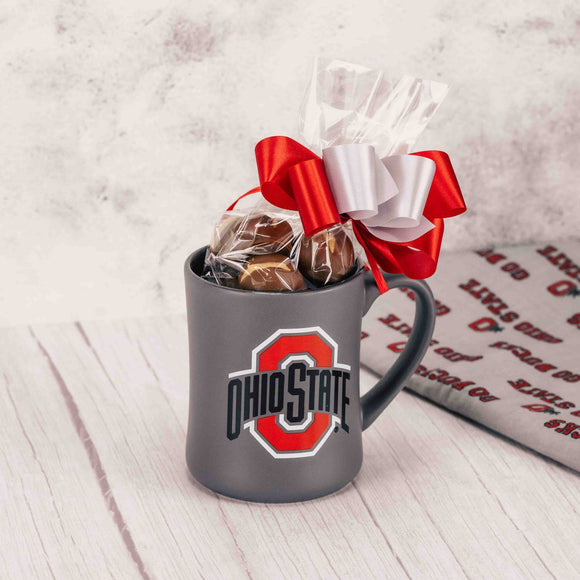 Enjoy sipping your cup of joe from this smooth, slate gray mug that has the Block O logo on both sides and is filled with over a half pound of our amazing Buckeyes. Tied with a handmade bow for an added touch! Mug is hand wash only.