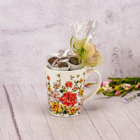 a half pound of our milk chocolate assorted candies packaged in a flower mug