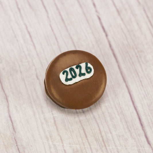 A milk chocolate covered Oreo cookie with '2026' written in icing. 