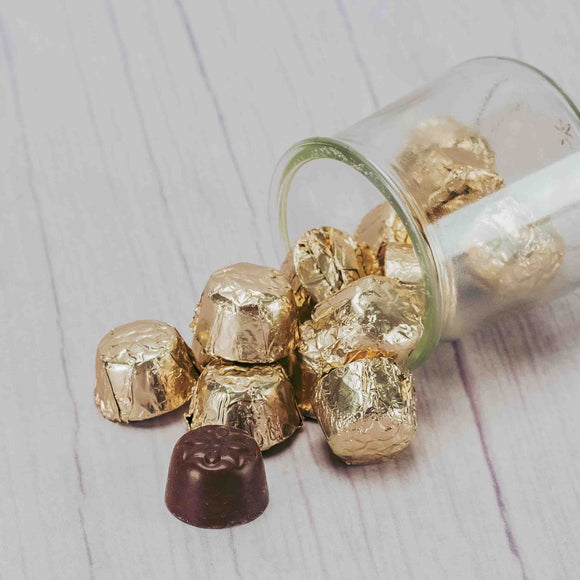 A half pound bag of supreme milk chocolate nugget pieces are wrapped in gold foil.