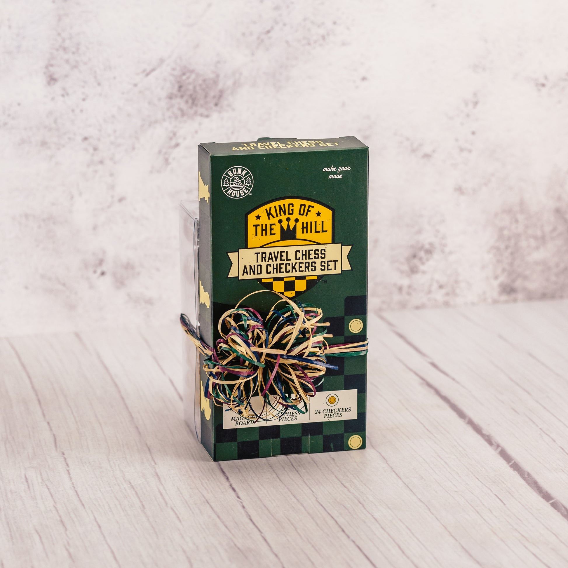 a travel magnetic chess and checkers game set is packaged with some malt balls and butter toffee peanuts