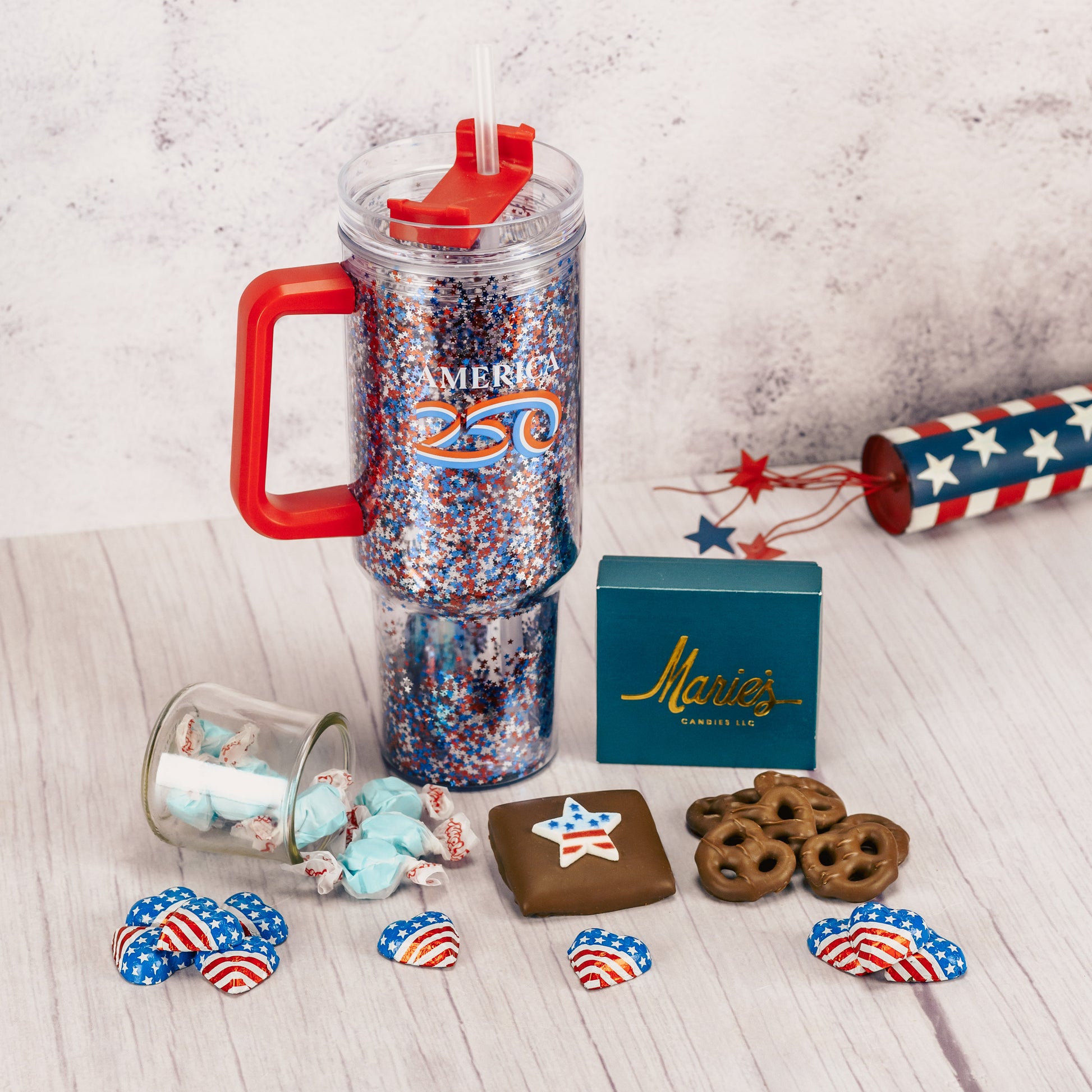 a 40 ounce travel mug that reads America 250 is filled with sweet treats!
