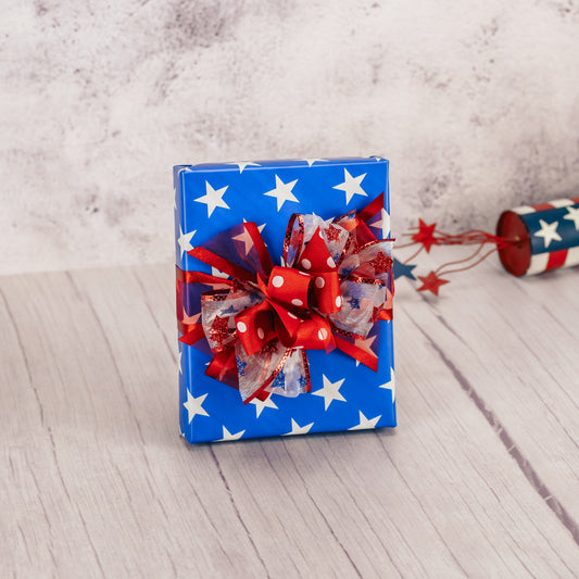 a half pound box of assorted chocolates is wrapped festively patriotic.