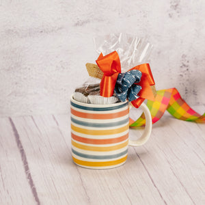 a fun vibrant striped mug is filled with over a half pound of assorted milk chocolates