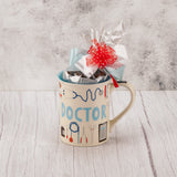 Thank the doctor(s) in your life with only the best, Marie's Candies! A half pound of exceptional Assorted Chocolates is filled to the brim of this unique mug that reads 'Doctor, This coffee is prescription strength'. The mug is dishwasher and microwave safe and tied with a lovely handmade bow for an added touch.   