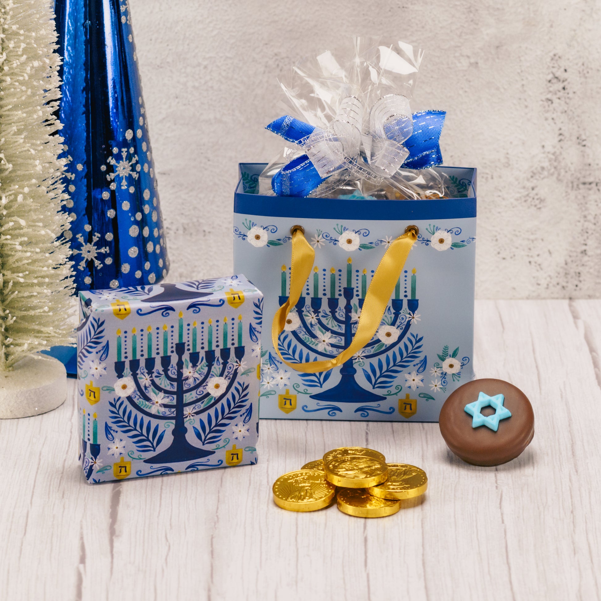 Gift bag with Menorah design filled with sweet treats for Hanukkah.