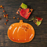 an orange pumpkin plate is packaged with a sampler box of assorted chocolates and a leaf pouch