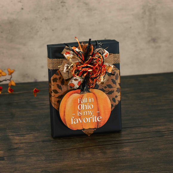 a half pound box of assorted chocolates is topped with a wooden pumpkin ornament that reads 'fall in Ohio is my favorite'