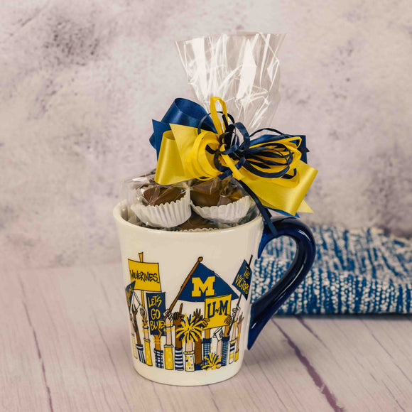 michigan fan arms with flags mug is filled with a half pound of assorted milk chocolates and one scarlet & gray Oreo on the bottom